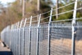 A security fence lines the edge of the property Royalty Free Stock Photo