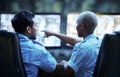 Security guard in control room, man and woman with screen to check cctv together in team office. Safety, surveillance Royalty Free Stock Photo