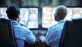 Security guard in control room, team checking screen of cctv computer together in secret office. Safety, surveillance Royalty Free Stock Photo