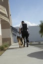 Security Guard With Dog On Patrol Royalty Free Stock Photo
