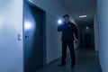 Security Guard With Flashlight Standing In Front Of Door Royalty Free Stock Photo