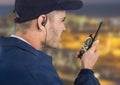 Security guard with headphone and walkie-talkie with a blurred night background Royalty Free Stock Photo