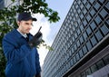 Security guard holding walkie talkie standing in city Royalty Free Stock Photo