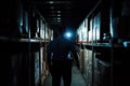 Security guard inspecting dark warehouse with flashlight Royalty Free Stock Photo