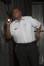 Security Guard Investigating With Torch Royalty Free Stock Photo