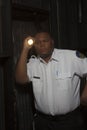 Security Guard Investigating With Torch Royalty Free Stock Photo