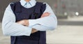 Security guard mid section arms folded against blurry street Royalty Free Stock Photo