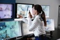 Security guard monitoring modern CCTV cameras in surveillance room