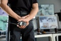 Security guard with portable radio transmitter monitoring modern CCTV cameras in surveillance room Royalty Free Stock Photo