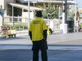 A security guard is seen from the back as he walks along the boardwalk in Atlantic City