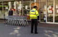 Security guard and shopping trolleys at a supermarket.