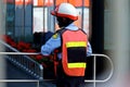 A security guard standing, catching a stainless bar