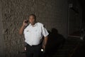 Security Guard With Walkie Talkie And Torch Patrols At Night Royalty Free Stock Photo