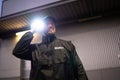 Security Guard Walking Building Perimeter With Flashlight Royalty Free Stock Photo