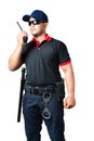 security guard wears dark glasses and wears a hat.holding a walkie-talkie with rubber batons ready and handcuffs on a tactical