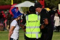 Security guards assiting people in outdoor public event