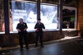 Security guards in front of a broken window during May 30, 2020 riots