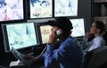 Security guards monitoring modern CCTV cameras in surveillance room