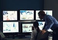 Security guards monitoring modern CCTV cameras in surveillance room Royalty Free Stock Photo