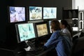 Security guards monitoring modern CCTV cameras in surveillance room Royalty Free Stock Photo