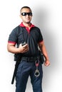 Security guards wear dark glasses. stand holding a radio There are rubber batons and handcuffs on the tactical belt. on isolated