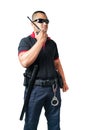 Security guards wear dark glasses. stand holding a radio There are rubber batons and handcuffs on the tactical belt. on isolated