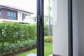 Security lock on glass window with green garden outside view