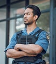 Security, police and man with crossed arms in city for working, inspection and supervision on patrol. Uniform, law Royalty Free Stock Photo