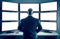 Security professional monitoring multiple blank screens in a control room