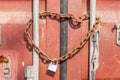 Security and Safety concept, a rusty metal chain and padlock wrapped around gateway entrance doors. Royalty Free Stock Photo