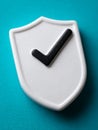Security shield icon with checkmark on teal background. Royalty Free Stock Photo