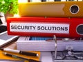 Security Solutions on Red Office Folder. Toned Image. 3D. Royalty Free Stock Photo