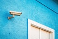 Security surveillance camera equipment mounted on blue house wall Royalty Free Stock Photo