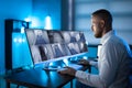 Security System Operator Looking At CCTV Footage At Desk Royalty Free Stock Photo