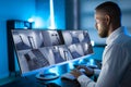 Security System Operator Looking At CCTV Footage At Desk Royalty Free Stock Photo