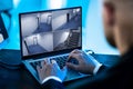 Security System Operator Looking At CCTV Footage At Desk Royalty Free Stock Photo