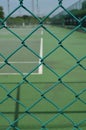 Security wire mesh fence with blurred tennis court background Royalty Free Stock Photo