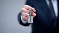 Security word on keychain in businessman hand, home safety system, guard service