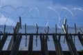 Security: Woven wire security fencing topped with razor wire. 4 Royalty Free Stock Photo