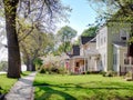 SEDALIA, USA, APR. 23, 2015: View on country street with private houses among blossom trees and lawns. American traditional countr