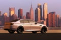 A sedan car infront of Manhattan skyline, USA