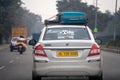 Sedan car with sticker for Ryde by Redbus a taxi cab hailing startup for travelling intercity for business, vacation or