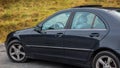 Sedan sport equipment car inside view through left side windows, leather interior, chromed elements, front and back seats