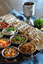 Seder dinner table with decorations, wine and food. Traditional Jewish kosher meals