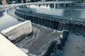 Sedimentation round tank in modern sewage or wastewater treatment plant, blue toned