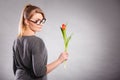 Seducive nerdy girl holding tulip. Royalty Free Stock Photo