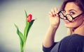 Seducive nerdy girl holding tulip. Royalty Free Stock Photo