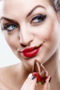 ÃÂ ÃÂ  Seduction - Attractive woman eating a strawberry, chocolate became the face of it Royalty Free Stock Photo