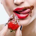 Seduction - red female lips with chocolate mouth , holding strawberries Royalty Free Stock Photo