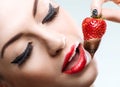 Seduction - red female lips eating chocolate strawberries Royalty Free Stock Photo